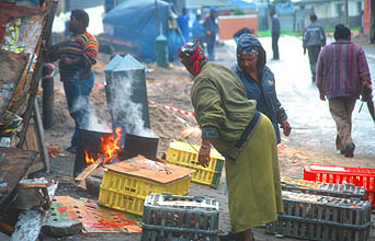 Cape Town Townships women preparing cooked chicken